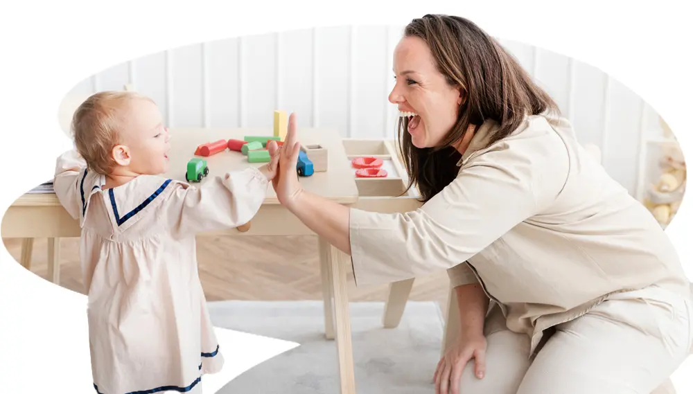 Baby Making High Five With Woman